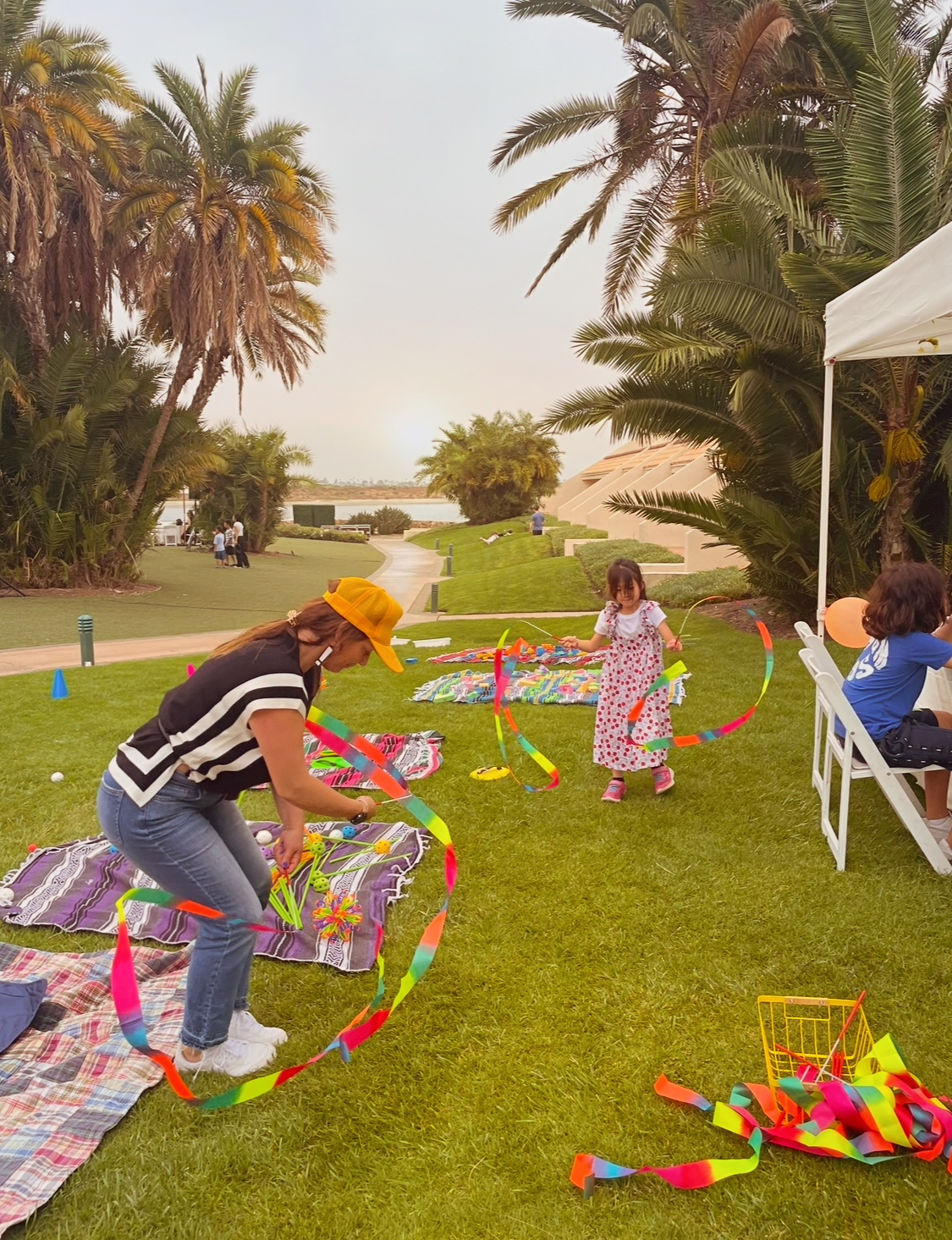 Kids playing with rainbow ribbon streamers at a BL!SS event